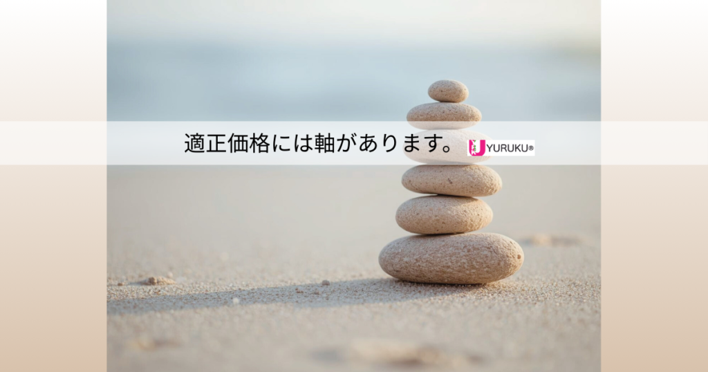静かな砂浜に積み上げられた石が美しいバランスを保っている様子